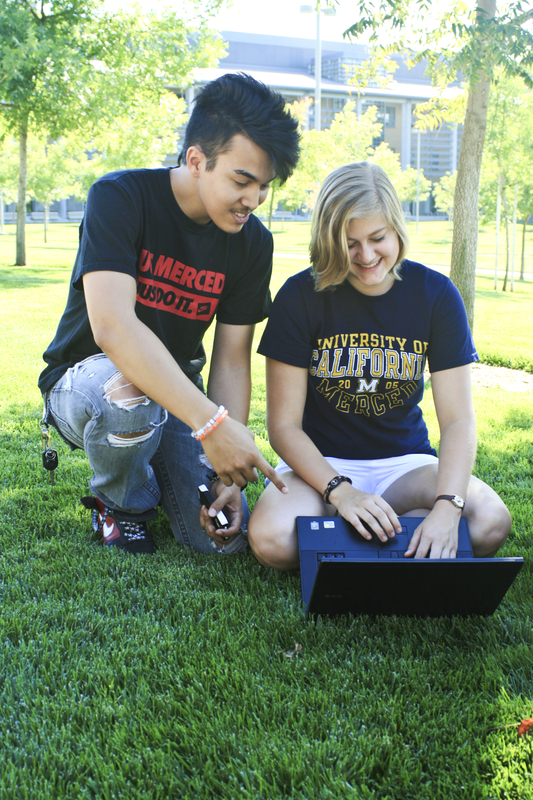 UC Merced students looking at a laptop